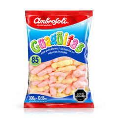 Una bolsa de 300 g de malvaviscos «Guagüitas» de Ambrosoli, con un diseño de envase en rojo y azul y una ventana transparente que deja ver los malvaviscos rosas y amarillos que hay en su interior.