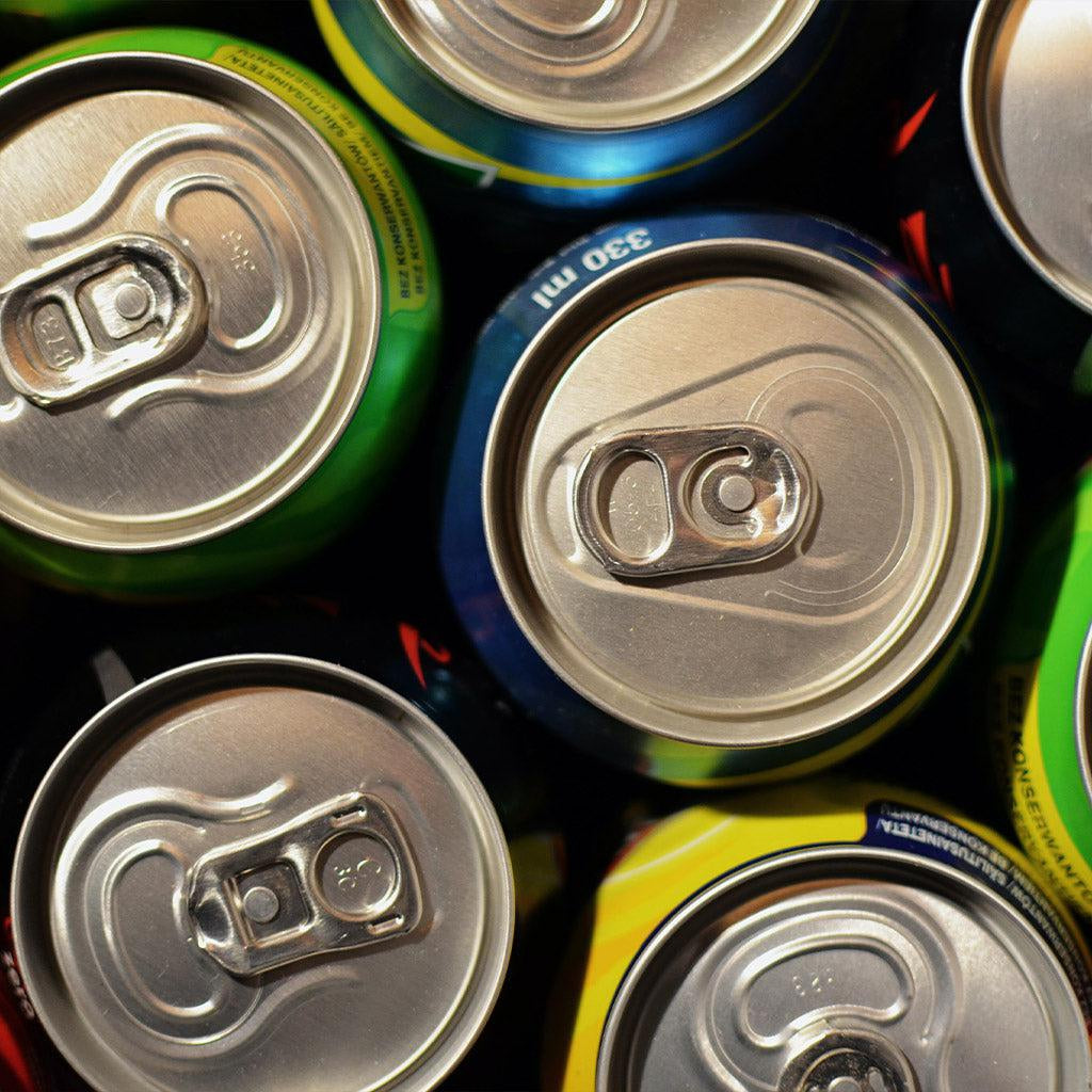 Cans of soda in blue, green, and yellow from Chile.