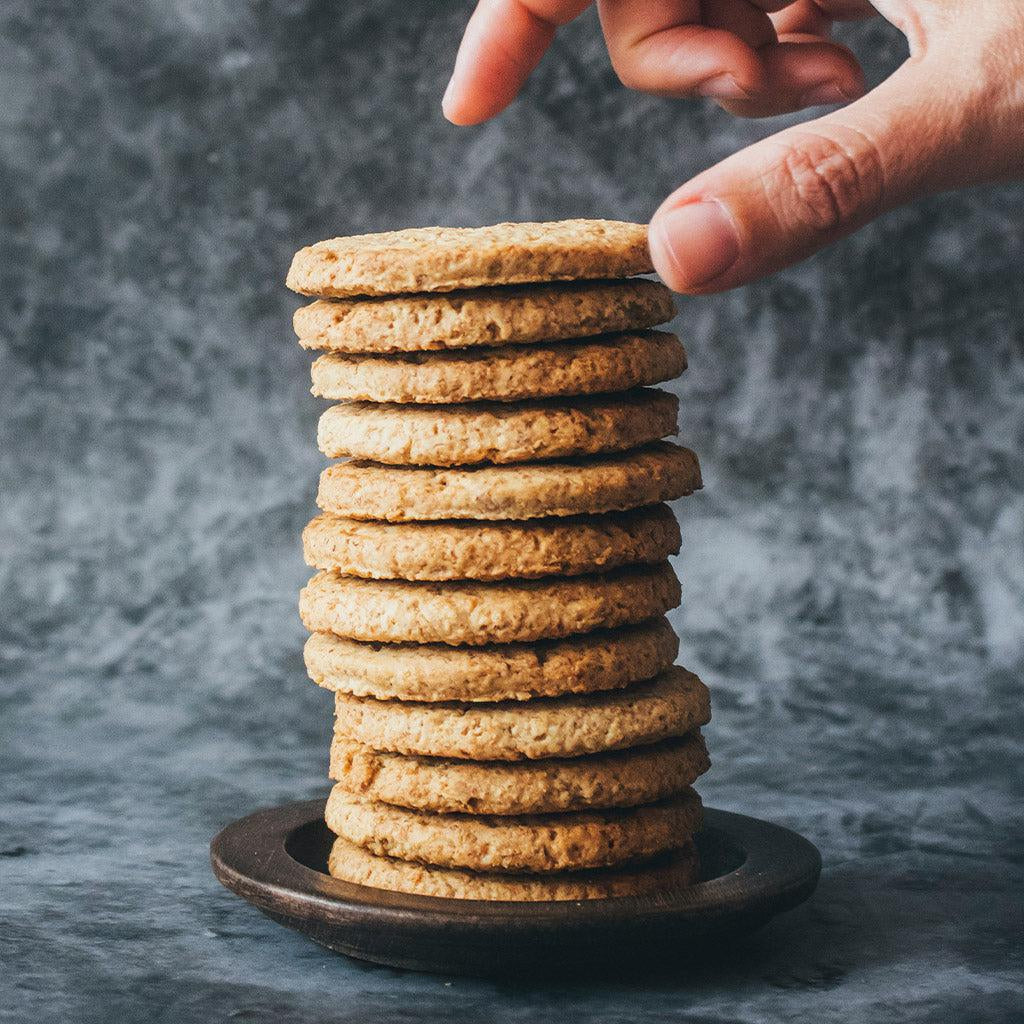 A hand grabbing from a stack of Chilean cookies.