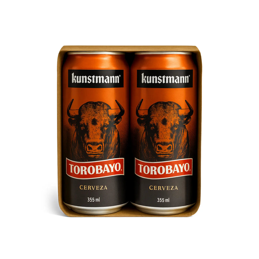 Four cans of Torobayo Cerveza beer in a cardboard holder with 'kunstmann' branding.