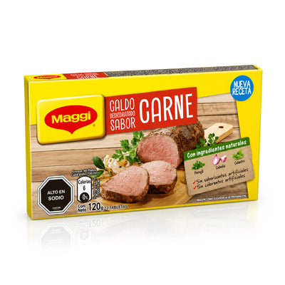 Una caja de «Maggi Caldo Deshidratado Sabor Carne» (caldo de setas y ternera) sobre un fondo blanco con un suave reflejo. El envase es principalmente de color amarillo, con texto en rojo y blanco, y muestra una imagen de carne cocida cortada en lonchas sobre una tabla de madera.