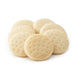 Close-up of pre-baked hallulla rolls arranged in a circular pattern on a white background.