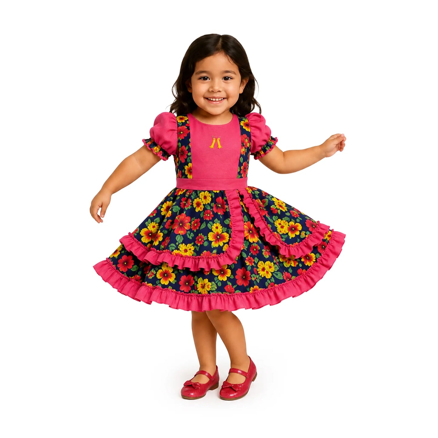 Girl wearing the Traditional Pink Floral Girls Vestido Huasa Chinita, a Chilean cueca dress with a pink bodice and navy floral skirt with pink ruffles.